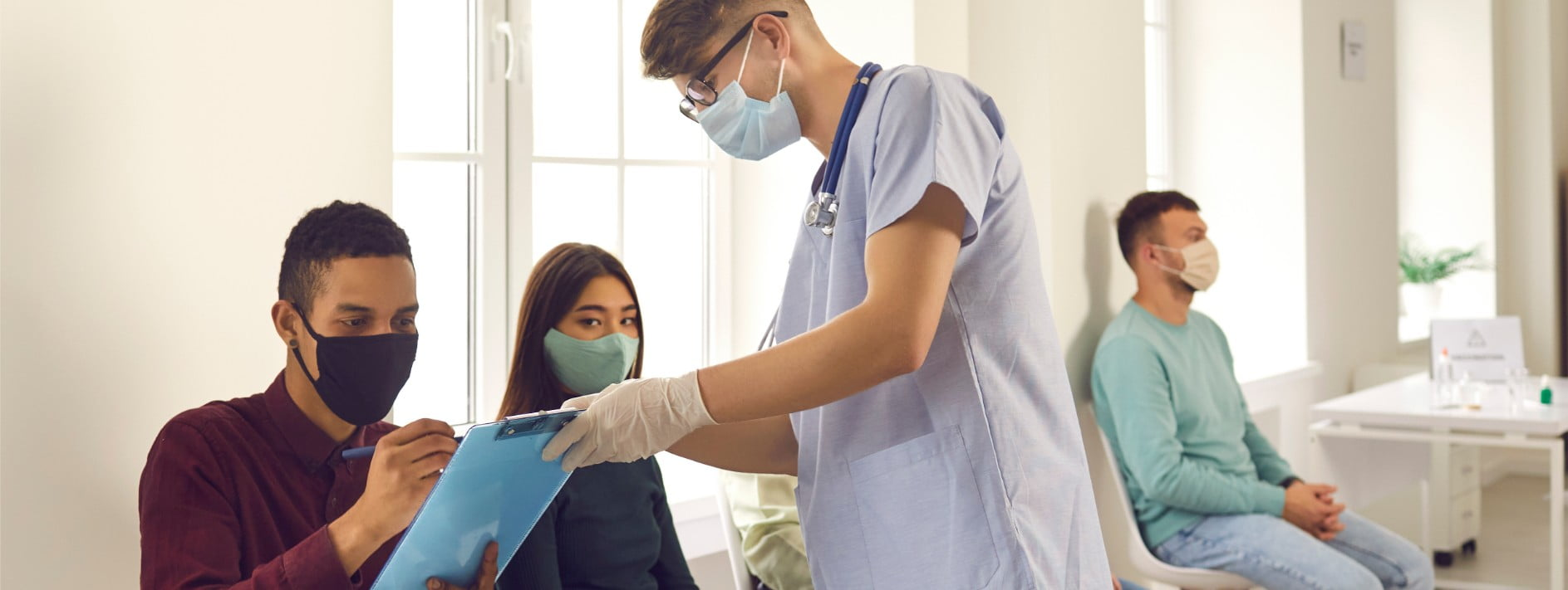 a medical professional helping a patient fill out a form