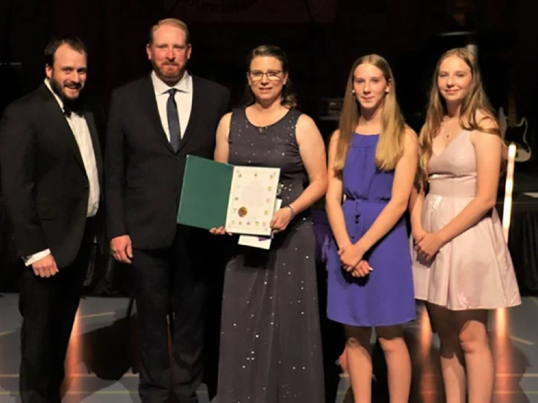 A picture of Michelle Bates accepting an award